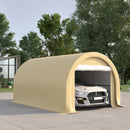 Beige portable garage with a car inside, surrounded by trees and a building.