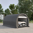 Portable garage shed with a car inside, surrounded by trees and a clear sky.