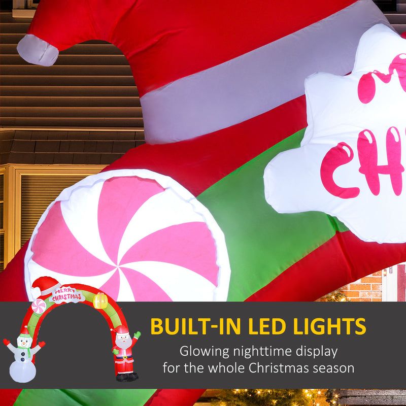Decorative inflatable Christmas decoration with candy cane, peppermint, and Santa Claus elements, featuring built-in LED lights.