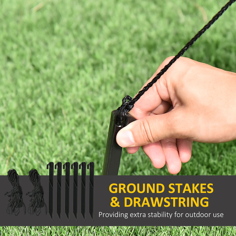 Hand using ground stakes and drawstring with grass background