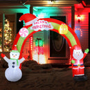 Inflatable Christmas arch with Santa Claus, snowman, and candy cane decorations in front of a house with holiday lights.