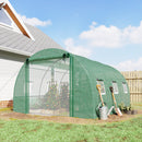10 x 13 Green greenhouse with gardening tools and plants in a backyard setting
