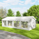 13 x 26 White party tent on a grassy area with trees in the background