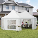 White octagonal outdoor canopy tent set up in a backyard with people sitting at a table.