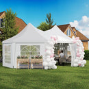 White party tent with balloon arches in a backyard setting