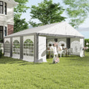 Outdoor 20 x 20 party tent with tables and chairs set up under a white canopy in a garden setting.