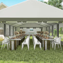 Outdoor event setup with tables, chairs, and decorations under a large 20 x 33 white tent.