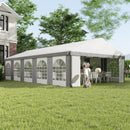 White outdoor 20 x 33 canopy tent with gray trim on a grassy area, trees, and house in the background.