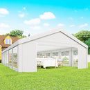 White 20 x 40 party tent with glass walls on a grassy area under a blue sky.
