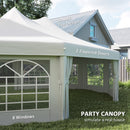 Party canopy with double top design, 2 zipped doors, and 8 windows in front of a house.