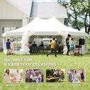 White tent with balloon arch in a backyard setting, suitable for various occasions.