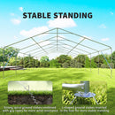 Outdoor canopy tent frame structure  with stable standing features on a grassy field with trees in the background.