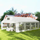 26 x 20 White outdoor canopy tent set up on a grassy area with chairs and tables underneath, in front of a house.