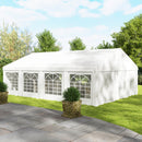 26 x 20 White outdoor party tent with glass panels on a grassy area with trees in the background