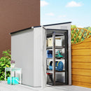 Metal storage shed with open door showing shelves and items, set against a garden backdrop.