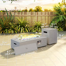 Outdoor fire pit table with measurements on a patio with plants and fence in the background