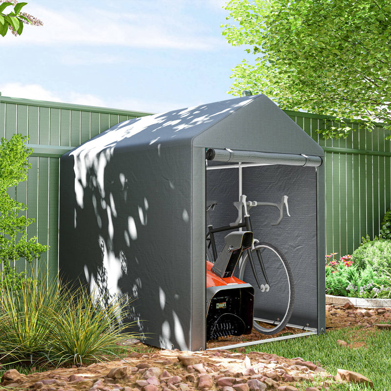 Gray storage shed with a bicycle inside, surrounded by greenery