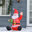 Inflatable Santa Claus decoration in front of a house with Christmas decorations.