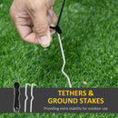 Hand securing a cable to a ground stake with grass in the background, featuring text about tethers and ground stakes.