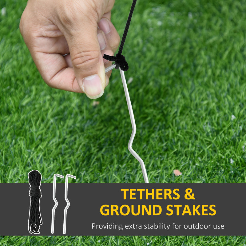 Hand securing a cable to a ground stake with grass in the background, featuring text about tethers and ground stakes.