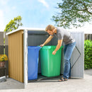 Man placing a green garbage bin into a 5x3 storage shed with blue recycling bin inside