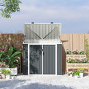Gray metal storage shed for garbage and recycling with a lifted roof lid in a garden setting with a lock on it. 
