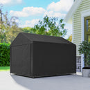 Black portable storage shed on a patio with a house and trees in the background