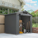 Portable gray outdoor storage shed 6x4 with a bicycle, firewood, and gardening tools in front of a house.