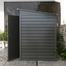 Gray metal storage shed with a door in an outdoor setting