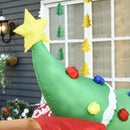 Inflatable Christmas tree decoration with a star on top, held by a person outdoors.