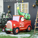 Large Christmas inflatable display  scene with a red truck carrying a decorated tree, set against a house exterior.