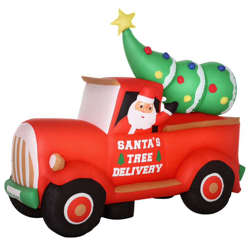 Large Christmas inflatable display of a red truck with Santa and a Christmas tree on a white background