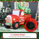 Large Christmas inflatable display  scene with a red truck carrying a decorated tree, featuring Santa Claus, on a snowy outdoor setting.
