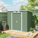7x4 green metal shed with a wooden deck in a backyard setting