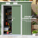 Green storage shed with double sliding doors, showing interior with tools and equipment.