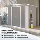7x4 grey modern garden storage shed with skis on a snowy day