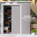 Grey garden storage shed with double sliding doors, showing interior with tools and equipment.