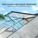 Two adjustable roof windows on a greenhouse with a clear blue sky background.