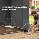 Person setting up a garden shed with an upgraded galvanized metal frame, steel wires, and ground stakes.