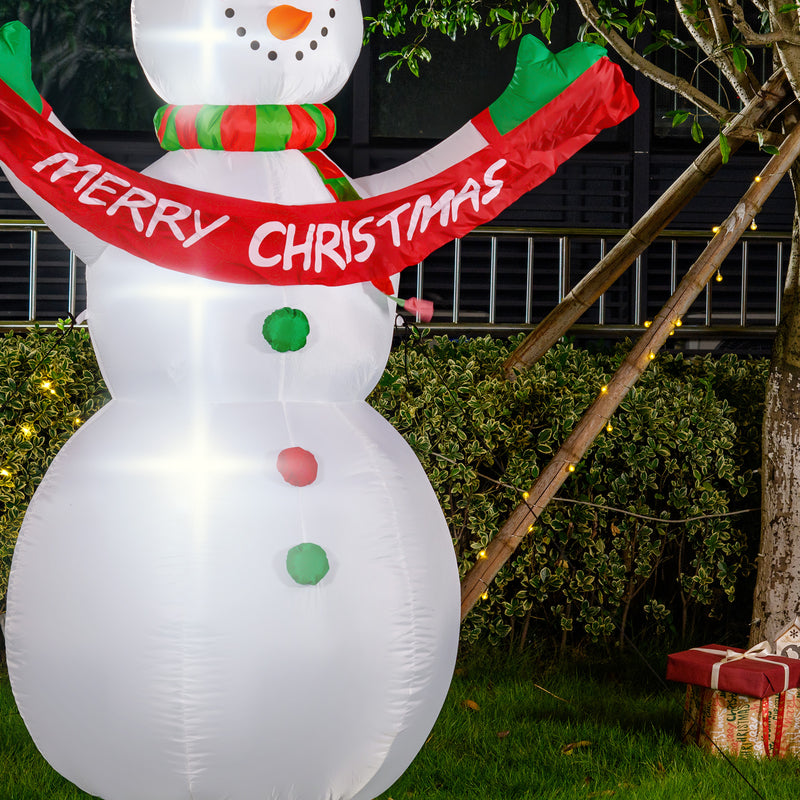 Inflatable snowman with a 'Merry Christmas' scarf in an outdoor setting.