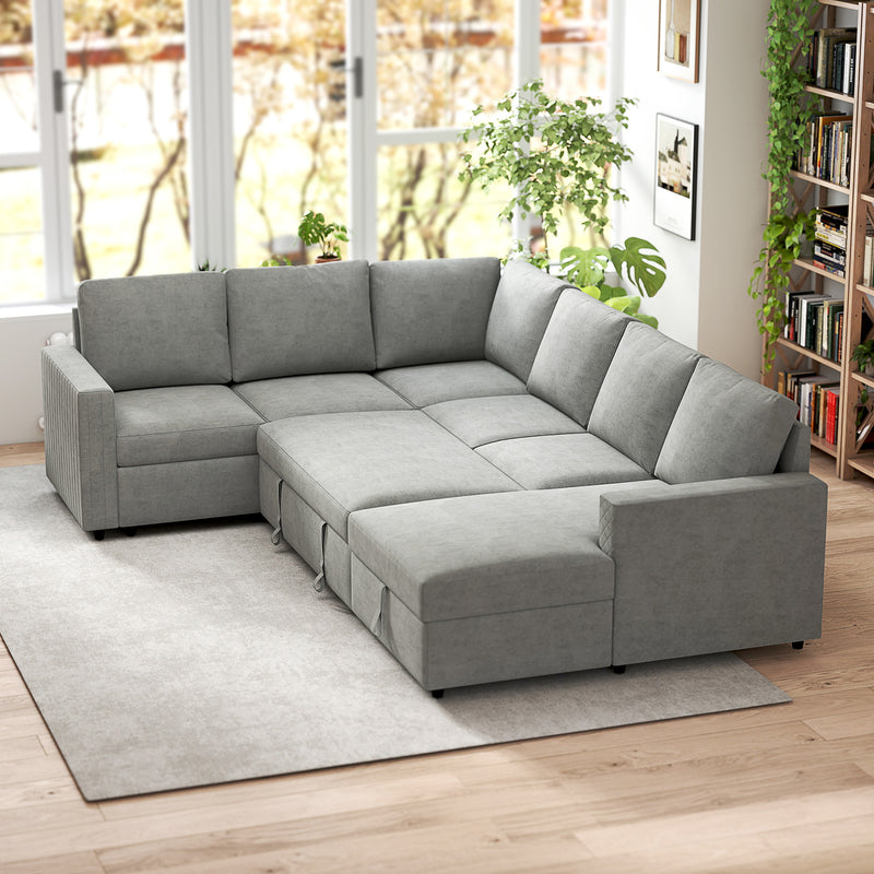 Gray sectional sleeper sofa in a living room with large windows and plants