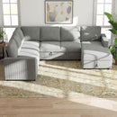 Gray sectional sleeper sofa in a living room with abstract art on the wall.