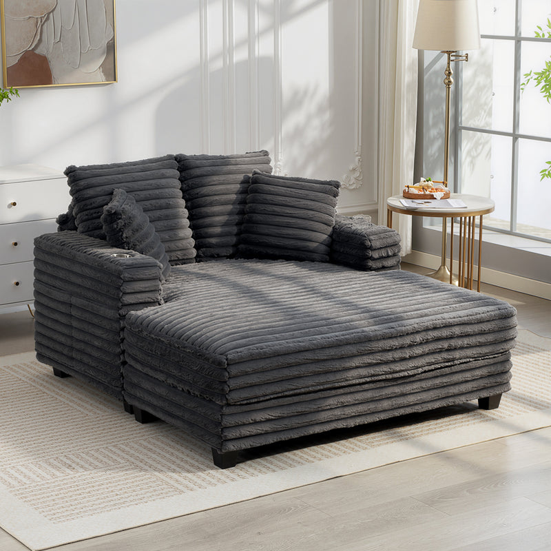 Oversized Chaise Lounge Comfy Chair with Grey Microfibre Corduroy Upholsteryin the middle of a living room setting. 