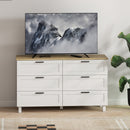 White dresser with wooden top displaying a mountain scene on a TV screen.