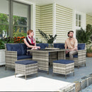 Two people sitting on outdoor furniture with blue cushions in a patio setting.
