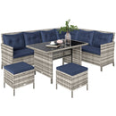 Outdoor furniture set with wicker chairs, table, and ottomans on a white background