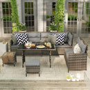 Outdoor patio set with light gray cushions and decorative pillows on a wooden deck.