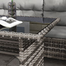 Wicker outdoor furniture set with a glass table and gray cushions.