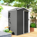 Lockable gray metal garden shed with a sliding door on a wooden deck, surrounded by plants and flowers.