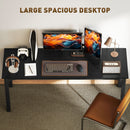 Large black desk with office equipment on a neutral background